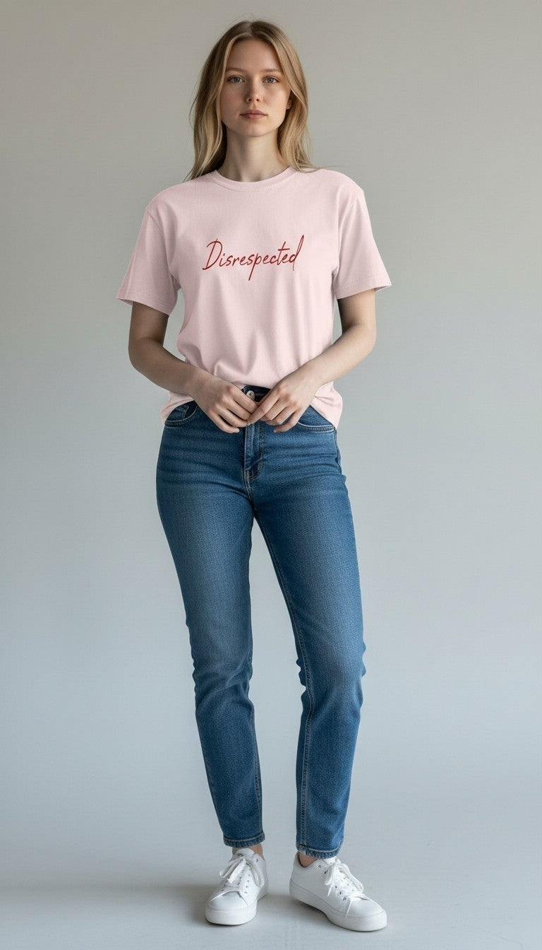 A model wearing a light pink Disrespected Clothing crewneck t-shirt with red script text, paired with blue jeans.
