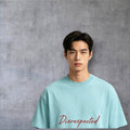 A man wearing a light blue Disrespected Clothing oversized cotton t-shirt with a drop shoulder and round neck.